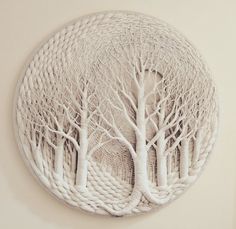 a white circular artwork with trees on it