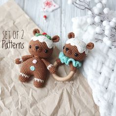 two crocheted teddy bears sitting next to each other on a piece of paper