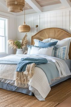 a bed with blue and white linens in a bedroom