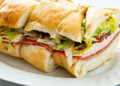 a cut in half sandwich sitting on top of a white plate