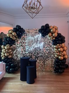 a happy birthday party with balloons and streamers on the wall, in front of a disco ball backdrop