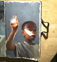 a painting of a young boy holding his hand up to the light coming from behind him