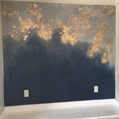 an empty room with blue and gold paint on the wall