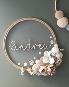 an embroidery hoop with the word and flowers on it