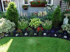 a garden with lots of different types of flowers and plants in the middle of it