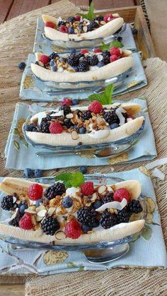 three plates with bananas and berries on them