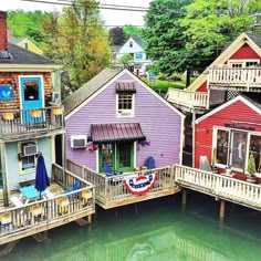 several colorful houses on stilts next to the water