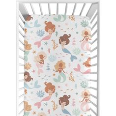 a white crib with mermaids and stars on it