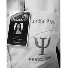 an id badge is attached to the back of a white jacket that has a woman's face on it