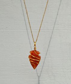 You are purchasing one handmade natural Carnelian crystal Arrowhead necklace pendant. These beautiful pendants are carefully cut, polished with care and have been personally chosen and selected under superior QC. We always prioritize the quality ahead and so as we use 100% genuine material in our Gemstones. ➤ Arrowhead Necklace size is Around 1 to 1.5 Inches What is Included? 1x Carnelian Spiral Arrowhead Necklace 1x Golden / Silver Chain for Women 1x Premium Adjustable Boho Cord for Men 1x Prem Hand Wrapped Carnelian Pendant Jewelry, Hand Wrapped Carnelian Pendant Necklace, Agate Crystal Pendant Necklace As Gift, Agate Pendant Crystal Necklace For Gift, Agate Necklace With Raw Stone For Gift, Spiritual Arrowhead Necklace Gift, Red Hand Wrapped Necklace As Gift, Hand Wrapped Agate Necklace For Gift, Hand Wrapped Red Necklace As Gift