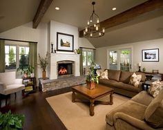 a living room filled with furniture and a fire place in the middle of a room