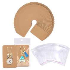 several pieces of crafting supplies including paper, scissors and earring clips with tags on them