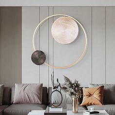 a living room filled with furniture and a large circular wall decoration above the couches