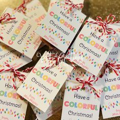 colorful christmas gift tags tied with red ribbon