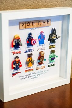 a white frame with lego minifigures in it on top of a table