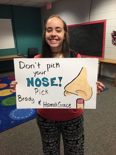 a girl holding up a sign that says don't pitch your nose pick