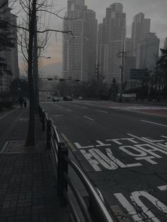 an empty city street with buildings in the background