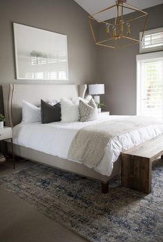 a large bed sitting in a bedroom next to a window