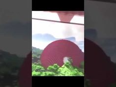 a blurry image of a red object in the air with mountains in the background