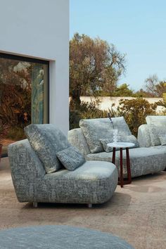 two couches and a coffee table on a patio