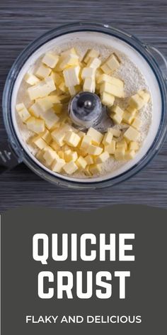 a food processor filled with cheese on top of a wooden table