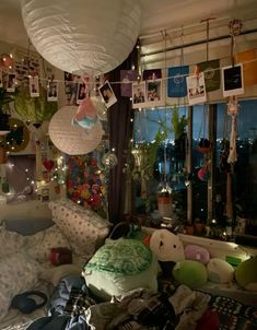 a room filled with lots of stuffed animals and pictures hanging from the ceiling above it