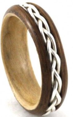 a wooden ring with white and brown braiding inlays on the inside of it