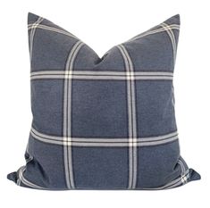 a blue and white plaid pillow on a white background