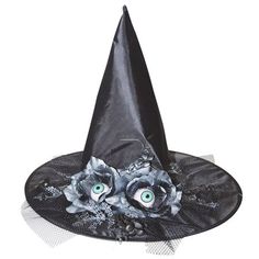 a black witches hat with flowers and eyes on the front, sitting on a white surface