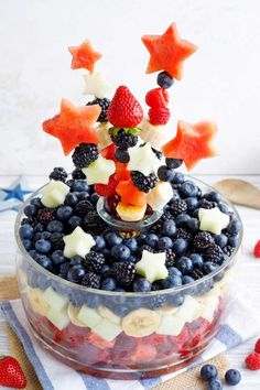 an image of fruit salad in a bowl with stars on top for 4th of july