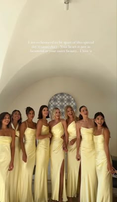 a group of women in yellow dresses standing next to each other on a white floor