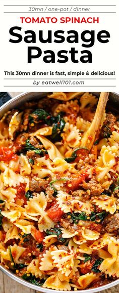 a pan filled with sausage pasta and spinach