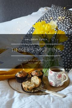 cupcakes and muffins on a tray with yellow flowers in the background