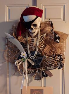 a skeleton wearing a pirate hat and pearls hangs on the front door to welcome guests