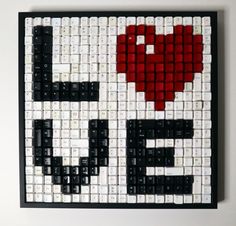 a piece of art made out of black and white tiles with a red heart on it