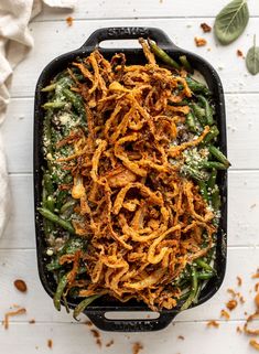 green bean casserole with crispy onions and parmesan cheese on top