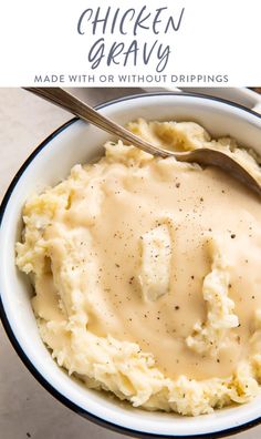 a bowl filled with mashed potatoes and gravy on top of a table