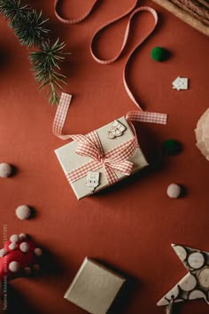 christmas presents are laid out on a red surface