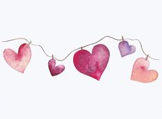 watercolor hearts hanging on a string against a white background