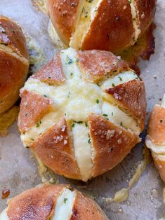 some bread rolls with cheese and herbs on them