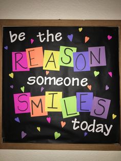 a bulletin board with the words be the reason someone smiles today written in multicolored letters