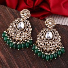 Add a touch of elegance to your ensemble with these stunning Green Aarti Chandbali Earrings. Crafted in traditional Indian jhumka style, these earrings feature a beautiful mix of gold and green elements, making them perfect for special occasions or adding a pop of color to your everyday look. Features: *Chandbali Design: A classic half-moon shape inspired by traditional Indian jewelry, embellished with intricate detailing. *Green & Gold Elegance: Features green beads and golden accents, with ref Green Jhumka, Indian Jhumka, Traditional Indian Jewellery, Chandbali Earrings, Traditional Earrings, Golden Earrings, Moon Shape, Gold And Green, Green Jewelry