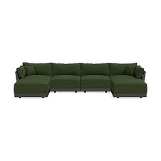 a large green couch sitting on top of a white floor