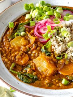 a bowl filled with rice, beans and veggies on top of a table