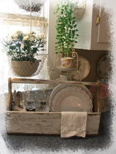 an old wooden box filled with dishes and plants