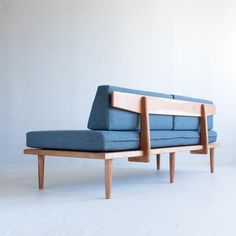 two blue couches sitting next to each other on top of a white flooring