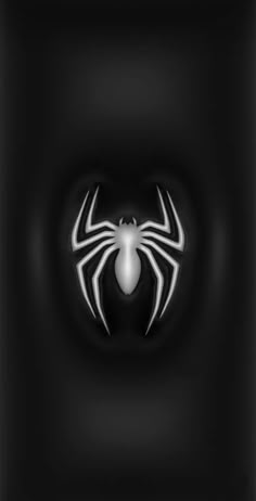 a black and white spider logo on a dark background