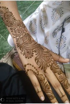 the hand is decorated with henna designs