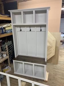 a large white shelf with two doors and some shelves