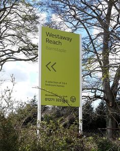 a yellow sign sitting in the middle of a forest